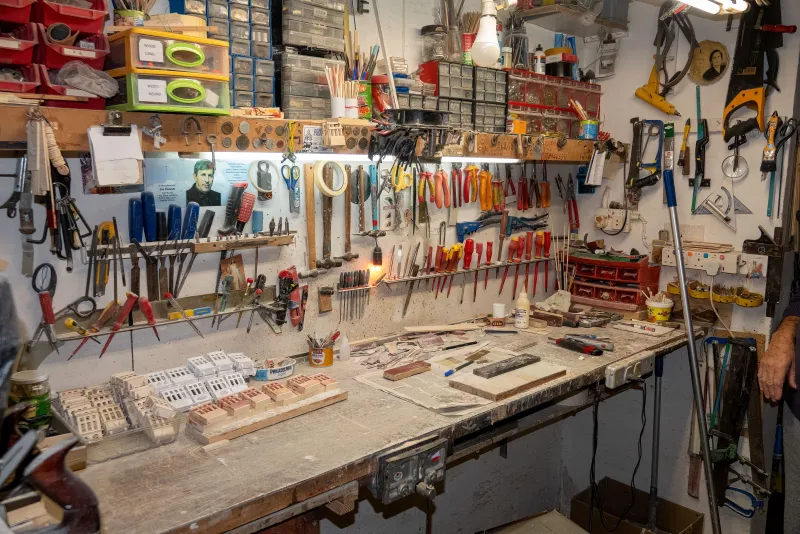 A pegboard wall of hand tools in a workshop